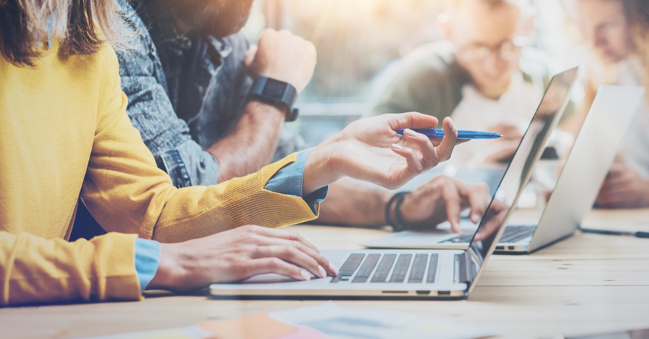 Closeup Group Young Coworkers Together Discussing Creative Project During Work Process.Modern Friends Business Meeting Discussion Startup Concept Office.Hipsters Hand Typing Laptop.Blurred.Wide
